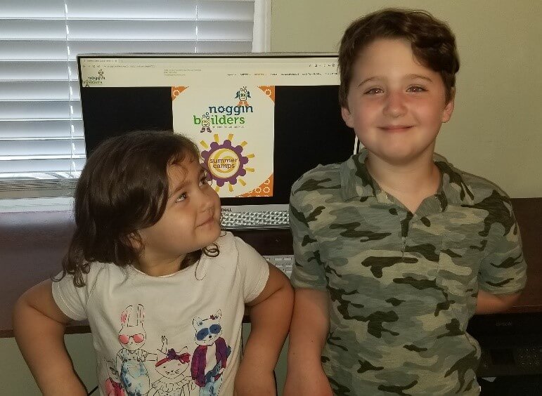 two kids of a NorthShore employee attending Noggin Builders virtual summer camp